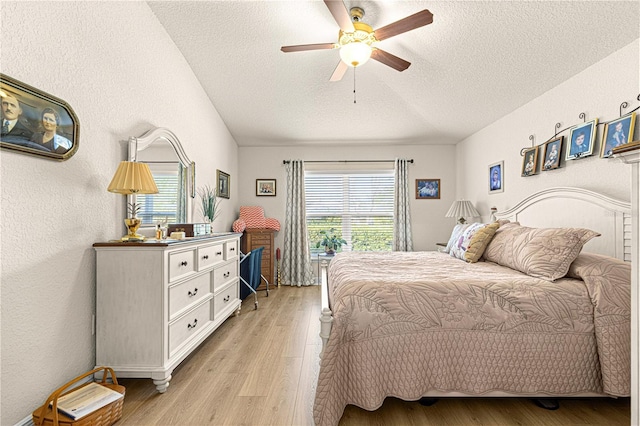 bedroom featuring ceiling fan, light hardwood / wood-style floors, and a textured ceiling