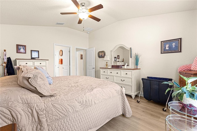 bedroom with light hardwood / wood-style flooring, ceiling fan, and lofted ceiling