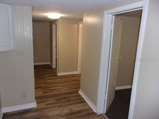 hallway with dark hardwood / wood-style floors