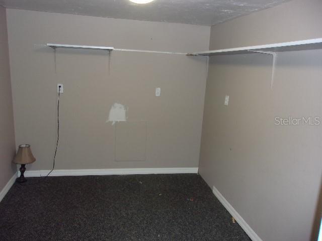 washroom featuring dark colored carpet