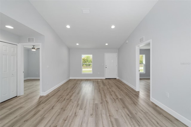 unfurnished room with ceiling fan, lofted ceiling, and light hardwood / wood-style flooring