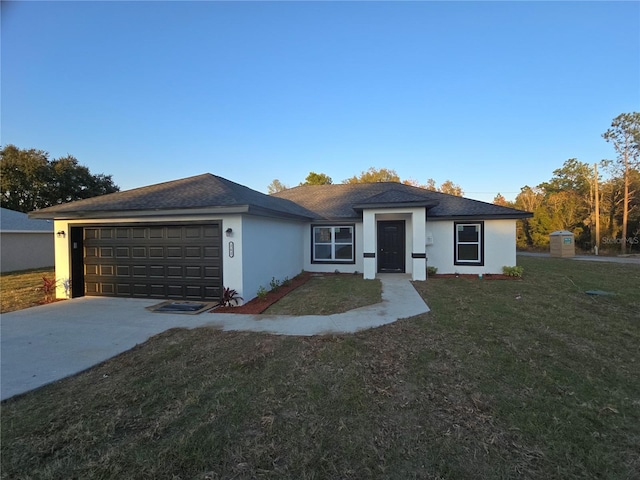 view of front of house with a front yard and a garage