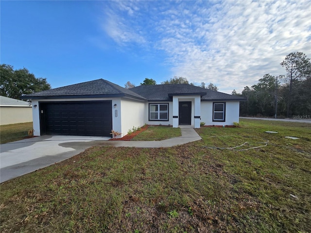 view of front of home featuring a garage and a front lawn