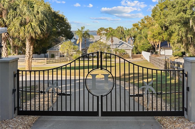 view of gate featuring a lawn