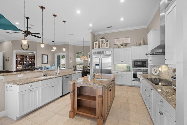 kitchen featuring built in appliances, a large island, hanging light fixtures, and white cabinets