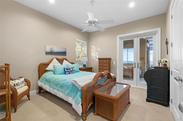 bedroom featuring access to outside, french doors, ceiling fan, and light carpet