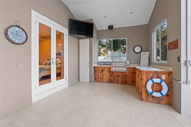 kitchen with sink, french doors, and vaulted ceiling