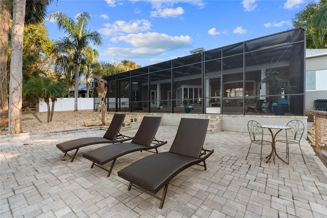 view of patio with glass enclosure