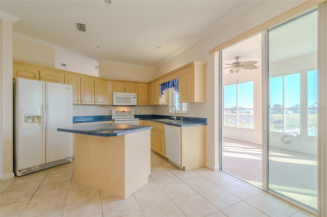 kitchen with light brown cabinets, white appliances, sink, ceiling fan, and a kitchen island