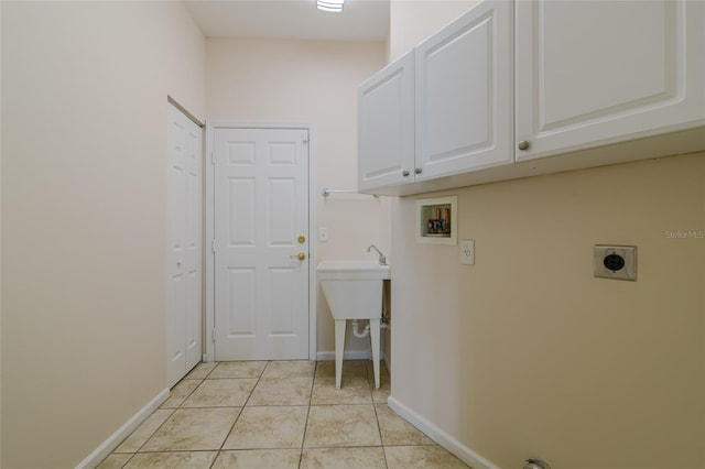 laundry room with cabinets, washer hookup, hookup for an electric dryer, and light tile patterned flooring