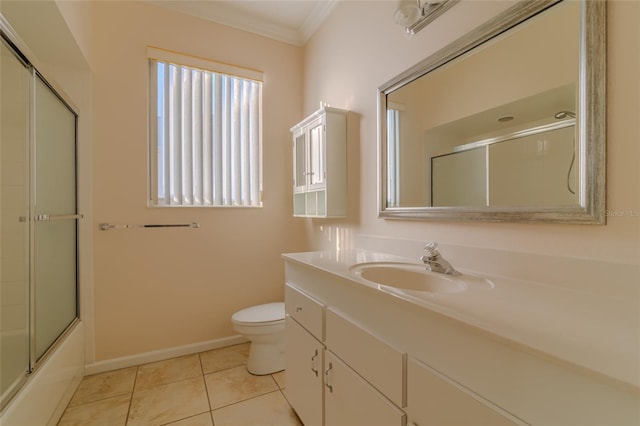 full bathroom featuring vanity, combined bath / shower with glass door, crown molding, tile patterned flooring, and toilet