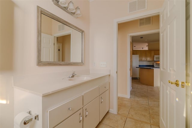 bathroom with tile patterned flooring and vanity