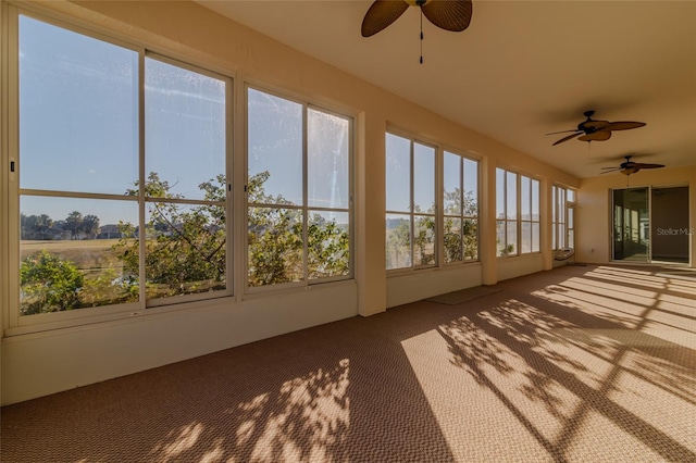 unfurnished sunroom with ceiling fan