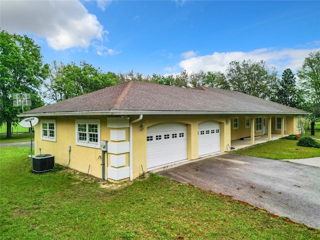 view of home's exterior featuring central AC, a yard, and a garage