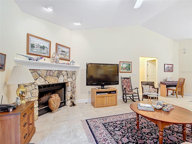 living room featuring a fireplace, light tile patterned floors, and vaulted ceiling