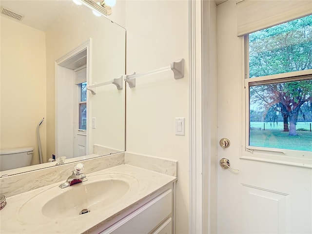 bathroom featuring vanity and toilet