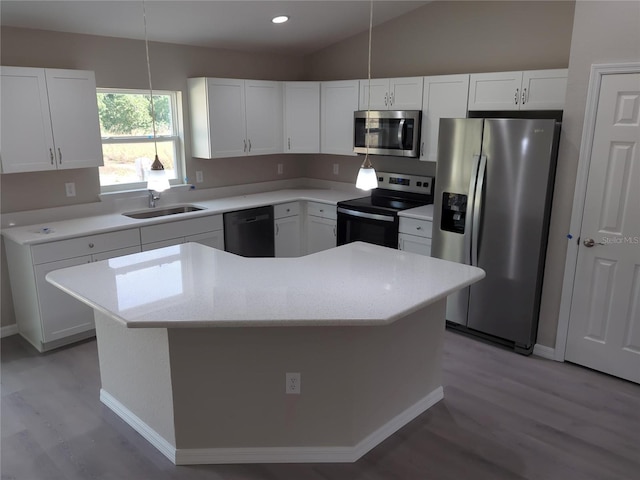 kitchen featuring white cabinetry, a center island, pendant lighting, and appliances with stainless steel finishes