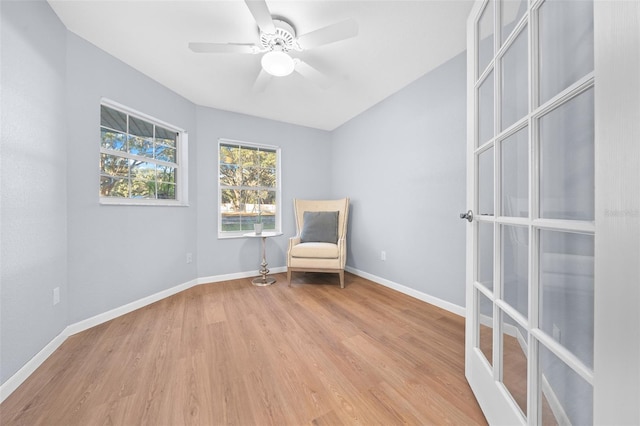 unfurnished room with ceiling fan, french doors, and light wood-type flooring