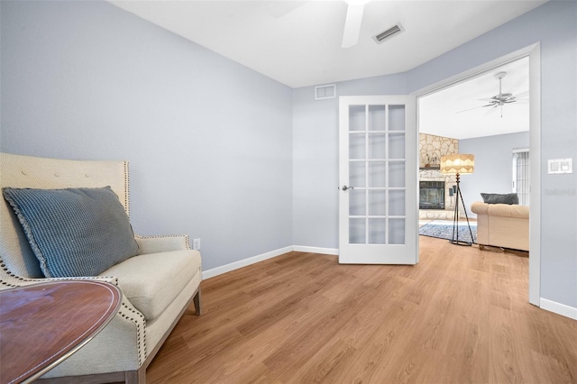 living area with light wood-type flooring and french doors