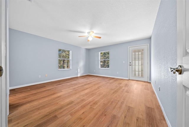 unfurnished room with ceiling fan and light wood-type flooring