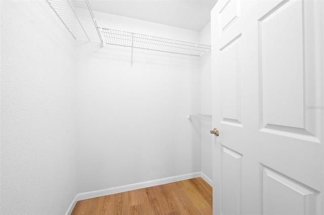 walk in closet featuring hardwood / wood-style floors