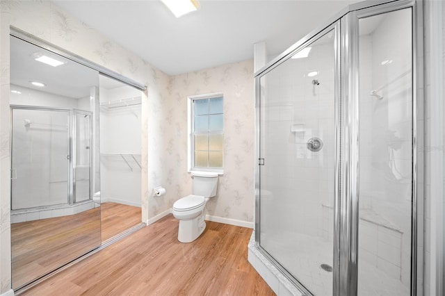 bathroom featuring wood-type flooring, an enclosed shower, and toilet