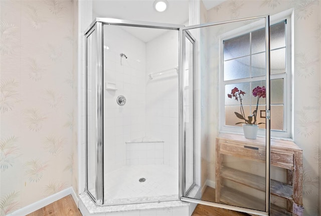 bathroom featuring wood-type flooring and an enclosed shower