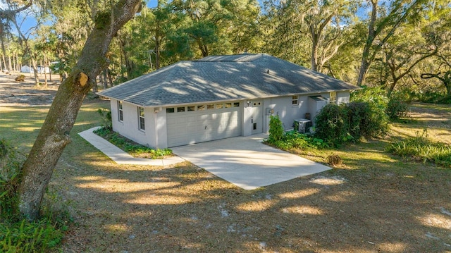 view of front of house featuring a garage and cooling unit