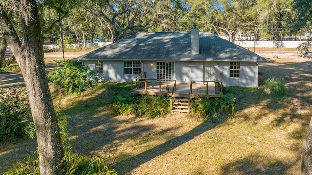 exterior space with a front lawn and a wooden deck