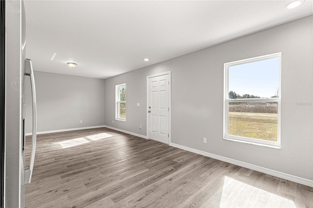 unfurnished room featuring light hardwood / wood-style floors