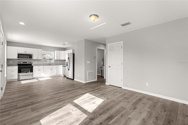 kitchen featuring wood-type flooring, white cabinetry, and stainless steel appliances