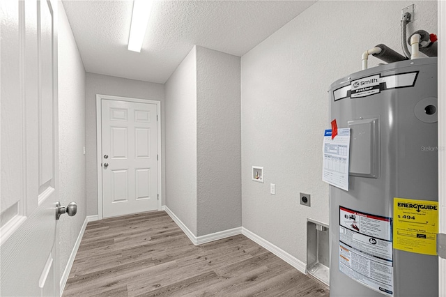 laundry area with hookup for a washing machine, light hardwood / wood-style flooring, a textured ceiling, water heater, and hookup for an electric dryer