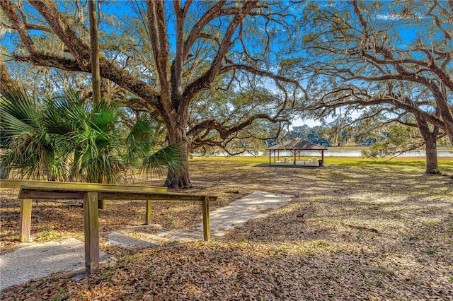 view of yard featuring a gazebo and a water view