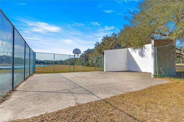 view of basketball court featuring a water view