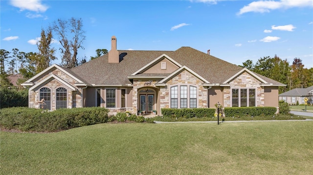 view of front of house with french doors and a front lawn