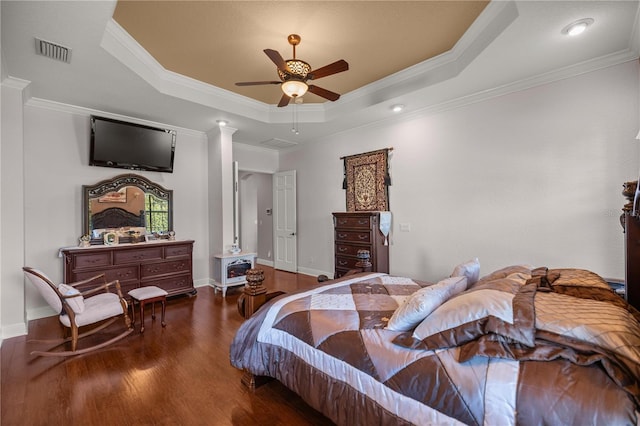 bedroom featuring dark hardwood / wood-style floors, a raised ceiling, ceiling fan, and crown molding