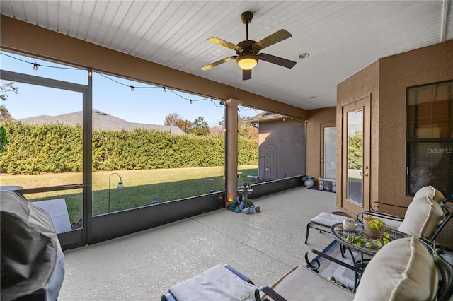 sunroom featuring a mountain view and ceiling fan