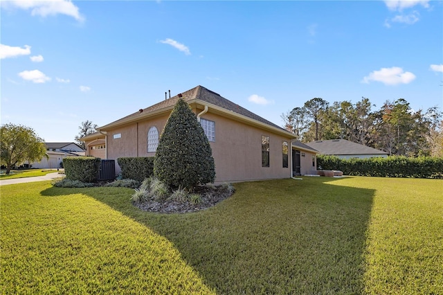 view of side of property with a lawn