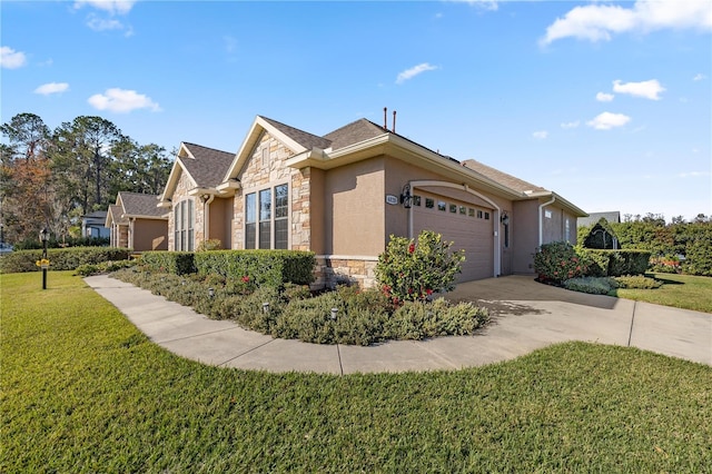 ranch-style house featuring a garage and a front lawn