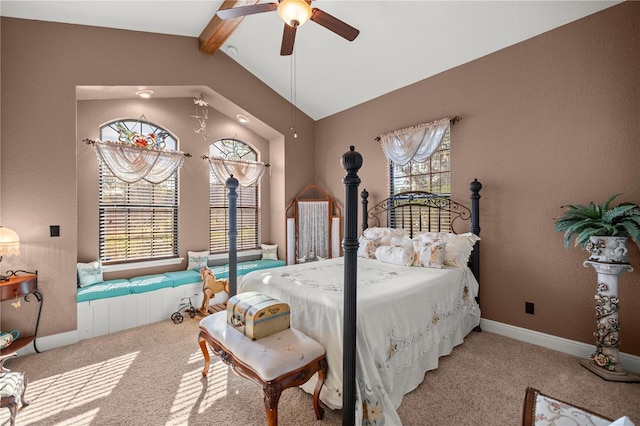 carpeted bedroom with multiple windows, ceiling fan, and lofted ceiling with beams