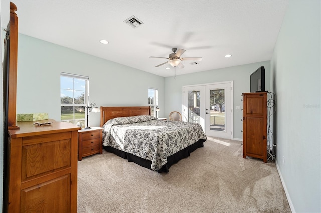 bedroom with access to exterior, light carpet, french doors, and ceiling fan