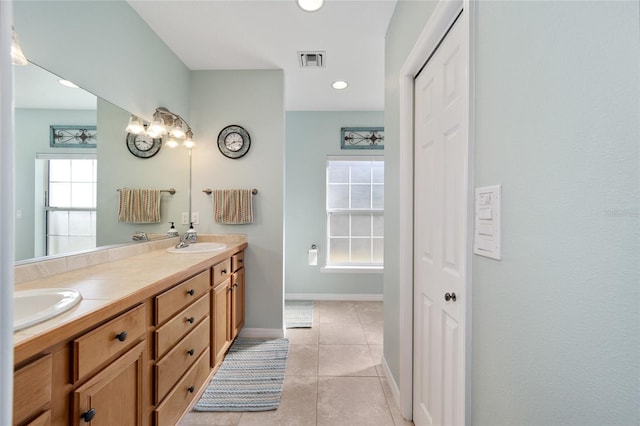 bathroom with plenty of natural light, vanity, and tile patterned flooring