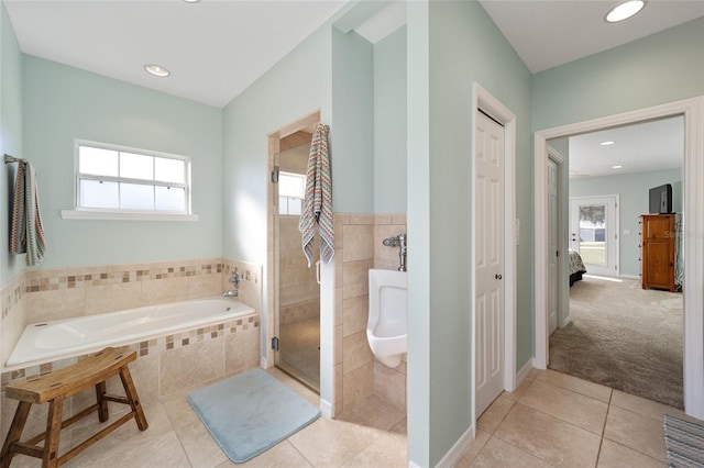 bathroom with separate shower and tub, tile patterned floors, and a wealth of natural light