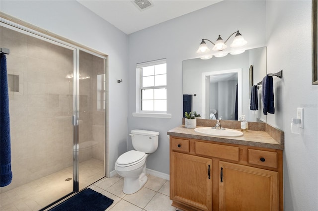 bathroom featuring tile patterned floors, vanity, an enclosed shower, and toilet