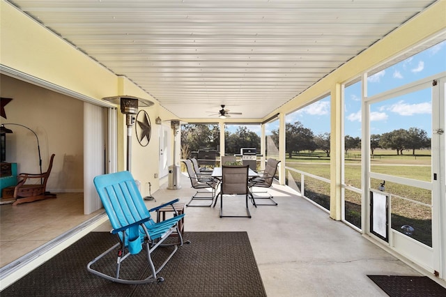 sunroom / solarium featuring ceiling fan