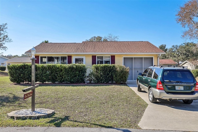 view of front of home with a front yard and a garage