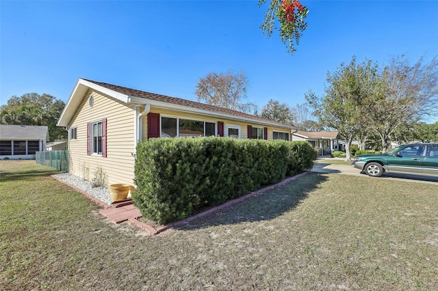 view of side of property featuring a yard