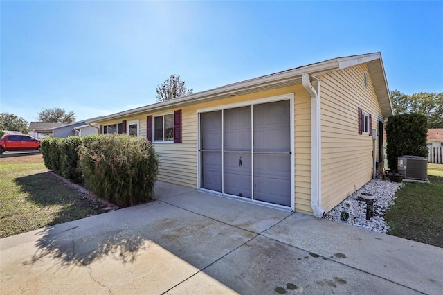 garage with a yard and cooling unit