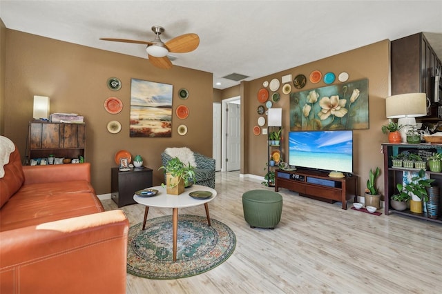 living room with hardwood / wood-style floors and ceiling fan