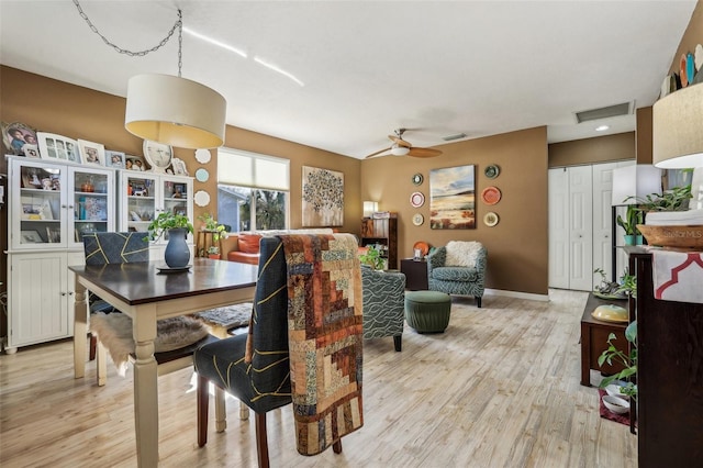 dining space with ceiling fan and light hardwood / wood-style floors